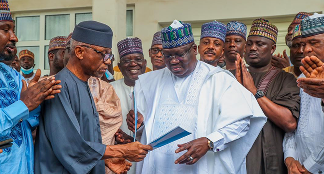 Chairman, National Stability Project, Chief Sam Nkire, presenting the Expression of Interest and Nomination forms of the All Progressives Congress to the Senate President, Ahmad Lawan, on May 9, 2022.  Credit: Tope Brown