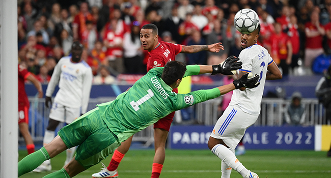 Real Madrid's Belgian goalkeeper Thibaut Courtois (C) makes a save during the UEFA Champions League final football match between Liverpool and Real Madrid at the Stade de France in Saint-Denis, north of Paris, on May 28, 2022. FRANCK FIFE / AFP