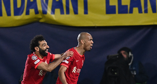 Liverpool's Brazilian midfielder Fabinho (R) celebrates with teammate Liverpool's Egyptian midfielder Mohamed Salah after scoring a goal during the UEFA Champions League semi final second leg football match between Liverpool and Villarreal CF at La Ceramica stadium in Vila-real on May 3, 2022. Paul ELLIS / AFP