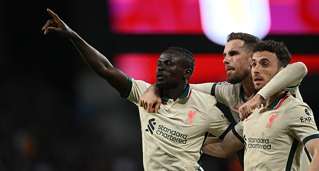 Liverpool's Senegalese striker Sadio Mane (L) celebrates scoring the team's second goal with Liverpool's English midfielder Jordan Henderson (C) and Liverpool's Portuguese striker Diogo Jota during the English Premier League football match between Aston Villa and Liverpool at Villa Park in Birmingham, central England on May 10, 2022. Paul ELLIS / AFP