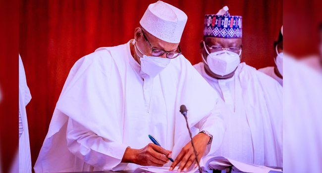 President Buhari signs Anti-Money Laundering Bills into Law in State House on May 12, 2022.