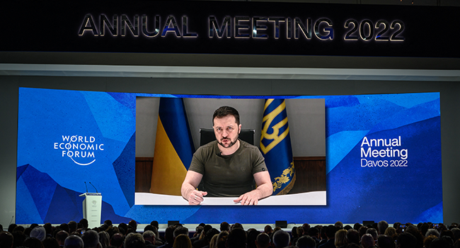 Ukrainian President Volodymyr Zelensky seen on a giant screen by video link delivering remarks at the Congress centre during the World Economic Forum (WEF) annual meeting in Davos on May 23, 2022. Fabrice COFFRINI / AFP