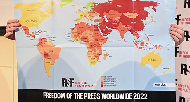 Reporters without Borders (Reporter sans frontieres - RSF) Director of Operations and Campaigns Rebecca Vincent shows the new 2022 World Press Freedom Index map during the Reporters Without Borders press conference, at Royal Overseas League, in London on May 3, 2022. JUSTIN TALLIS / AFP