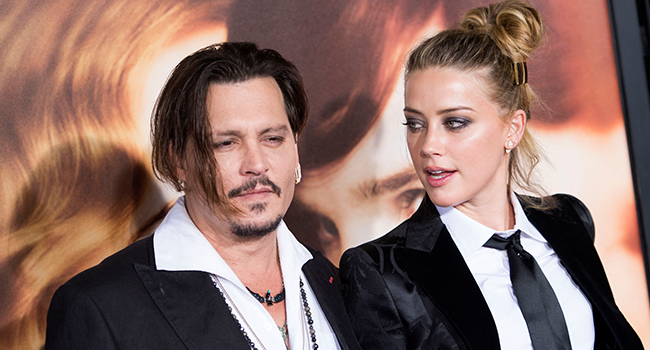 In this file photo taken on November 21, 2015 Actors Johnny Depp (L) and Amber Heard attend the Los Angeles Premiere of "The Danish Girl", in Westwood, California. VALERIE MACON / AFP
