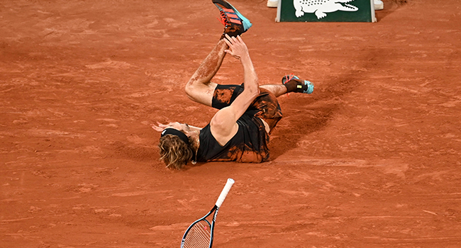 Germany's Alexander Zverev falls injured on court during his men's semi-final singles match against Spain's Rafael Nadal on day thirteen of the Roland-Garros Open tennis tournament at the Court Philippe-Chatrier in Paris on June 3, 2022. Tomas Stevens / AFP