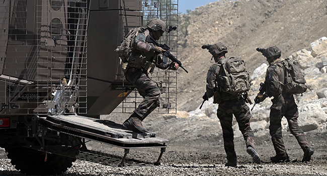 French army soldiers disembark from an VBMR Griffon armoured vehicle as they take part in a demonstration at the Eurosatory international land and airland defence and security trade fair, in Villepinte, a northern suburb of Paris, on June 12, 2022. Emmanuel DUNAND / AFP