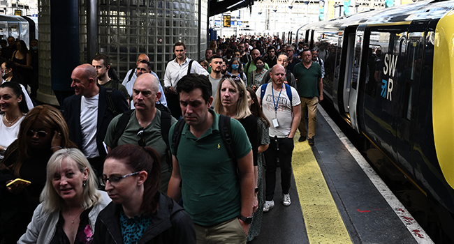 Passengers disembark a train at Waterloo Station in London on June 21, 2022 as the biggest rail strike in over 30 years hits the UK. Ben Stansall / AFP