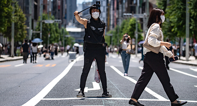 A man films on a street in Tokyo's Ginza district on June 26, 2022. Philip FONG / AFP