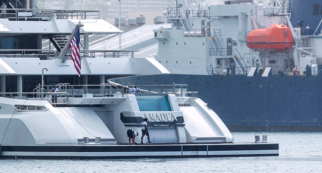 In this file photo taken on June 16, 2022 crew members get the mooring ropes ready as the yacht Amadea of sanctioned Russian Oligarch Suleiman Kerimov, seized by the Fiji government at the request of the US, arrives at the Honolulu Harbor, Hawaii. Photo by Eugene TANNER / AFP