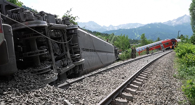 This video grab taken from footage of Network Pictures on June 3, 2022 shows rescue services at the site of a derailed train near Burgrain near Garmisch-Partenkirchen, southern Germany. NETWORK PICTURES / AFP