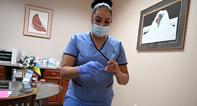 A medical assistant checks a patient's pregnancy test result at the Women's Reproductive Clinic, which provides legal medication abortion services, in Santa Teresa, New Mexico, on June 17, 2022. Robyn Beck / AFP