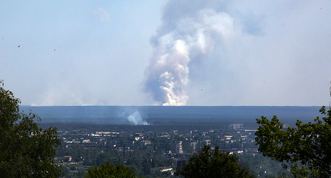 A picture taken on June 21, 2022 from the town of Lysychansk, shows a large plume of smoke rising on the horizon, behind the town of Severodonetsk, amid the Russian invasion of Ukraine. Anatolii Stepanov / AFP