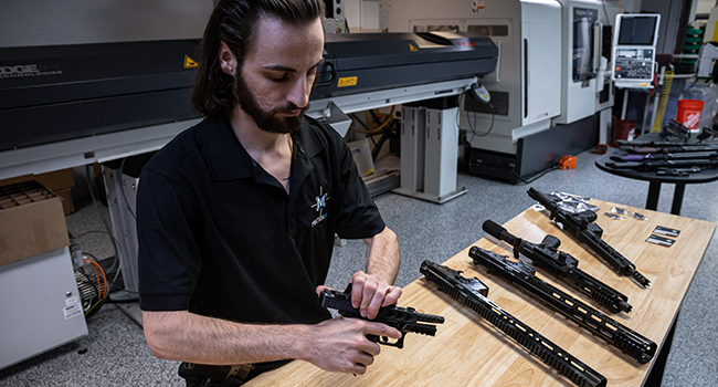 Matrix Arms owner and gun manufacturer Allen Farris displays a new pistol made by his company, at his factory in Claremont, New Hampshire on June 3, 2022. Ed JONES / AFP