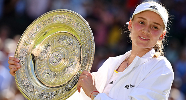 Kazakhstan's Elena Rybakina celebrates with the Venus Rosewater Dish trophy during the podium ceremony after winning the women's singles final tennis match against Tunisia's Ons Jabeur on the thirteenth day of the 2022 Wimbledon Championships at The All England Tennis Club in Wimbledon, southwest London, on July 9, 2022. (Photo by SEBASTIEN BOZON / AFP) /