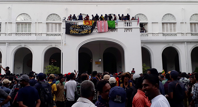 Protestors demanding the resignation of Sri Lanka's President Gotabaya Rajapaksa gather inside the compound of Sri Lanka's Presidential Palace in Colombo on July 9, 2022. (Photo by AFP)