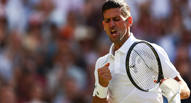 Serbia's Novak Djokovic celebrates beating Britain's Cameron Norrie during their men's singles semi final tennis match on the twelfth day of the 2022 Wimbledon Championships at The All England Tennis Club in Wimbledon, southwest London, on July 8, 2022. (Photo by Adrian DENNIS / AFP)