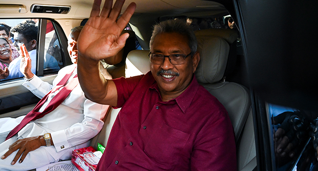 In this file photo taken on November 17, 2019, Sri Lanka's President-elect Gotabaya Rajapaksa waves to supporters as he leaves the election commission office in Colombo. Photo by Ishara S. KODIKARA / AFP