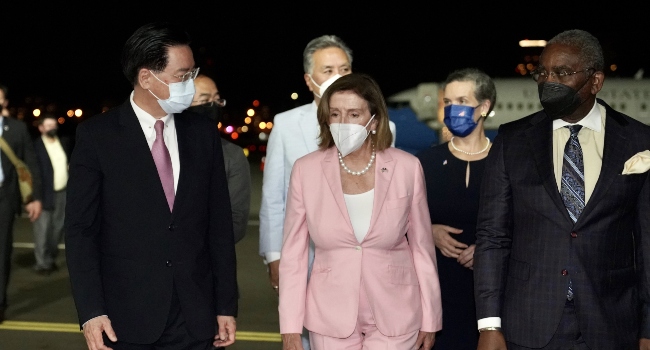 US House Speaker Nancy Pelosi (C) being welcomed by Taiwanese Foreign Minister Joseph Wu (L) after landing at Songshan Airport in Taipei, Taiwan on August 2, 2022.