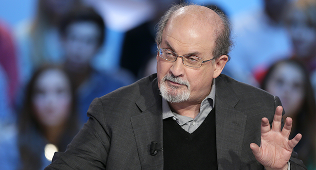 In this file photo taken on November 16, 2012, British author Salman Rushdie takes part in the TV show "Le grand journal" on a set of French TV Canal+ in Paris. Photo by Kenzo TRIBOUILLARD / AFP