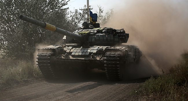 A Ukrainian tank rolls down a road at a position along the front line in the Donetsk region on August 15, 2022, amid Russia's invasion of Ukraine. (Photo by Anatolii Stepanov / AFP)