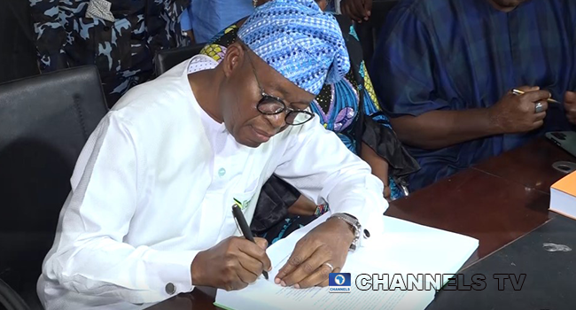 Isiaka Oyetola signs a petition challenging the Osun 2022 governorship elections.