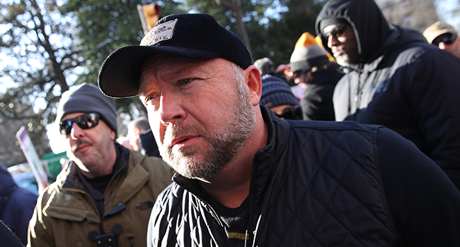  In this file photo taken on January 20, 2020 radio show host Alex Jones joins thousands of gun rights advocates attending a rally organized by The Virginia Citizens Defense League on Capitol Square near the state capitol building in Richmond, Virginia. (Photo by WIN MCNAMEE / GETTY IMAGES NORTH AMERICA / AFP)