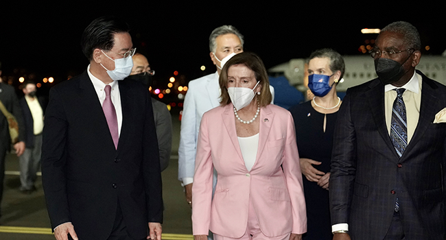 US House Speaker Nancy Pelosi (C) being welcomed by Taiwanese Foreign Minister Joseph Wu (L) after landing at Songshan Airport in Taipei, Taiwan on August 2, 2022. Taiwanese Foreign Ministry / Handout / Anadolu Agency