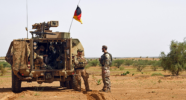 This file photo taken on August 2, 2018 shows German soldiers from the parachutists detachment of the MINUSMA (United Nations Multidimensional Integrated Stabilization Mission in Mali) searching for IED (improvised explosive device) during a patrol on the route from Gao to Gossi, Mali. (Photo by SEYLLOU / AFP)