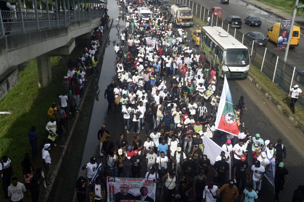 Supporters of presidential candidate of the Labour Party Peter Obi and running mate Datti Baba-Ahmed march during a campaign rally in Lagos, on October 1, 2022. (Photo by PIUS UTOMI EKPEI / AFP)