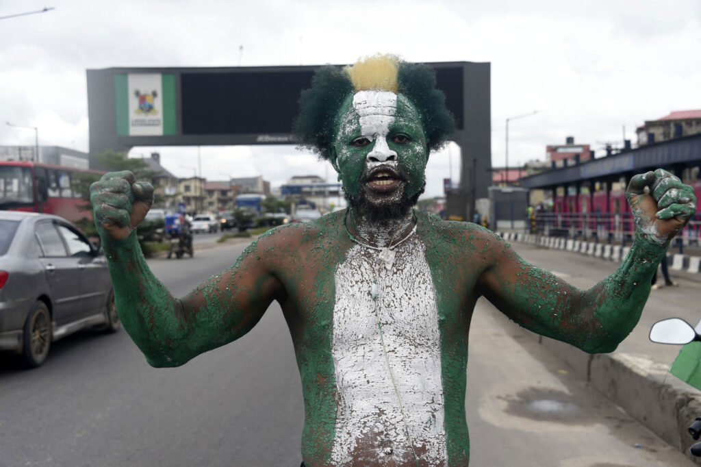 A supporter wears national green and white colours to campaign for candidate of Labour Party Peter Obi during a campaign rally in Lagos, on October 1, 2022. (Photo by PIUS UTOMI EKPEI / AFP)