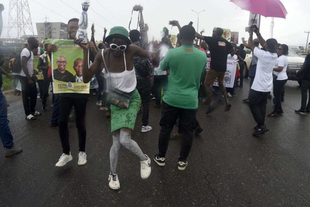 People dance in support of candidate of Labour party Peter Obi during a campaign rally in Lagos, on October 1, 2022. (Photo by PIUS UTOMI EKPEI / AFP)