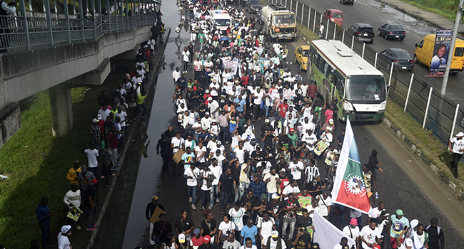 Supporters of presidential candidate of the Labour Party Peter Obi and running mate Datti Baba-Ahmed march during a campaign rally in Lagos, on October 1, 2022. (Photo by PIUS UTOMI EKPEI / AFP)