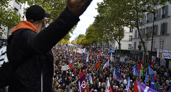 Protesters march towards Place de la Bastille during a rally against soaring living costs and climate inaction called by French left-wing coalition NUPES (New People's Ecologic and Social Union) in Paris on October 16, 2022. (Photo by JULIEN DE ROSA / AFP)