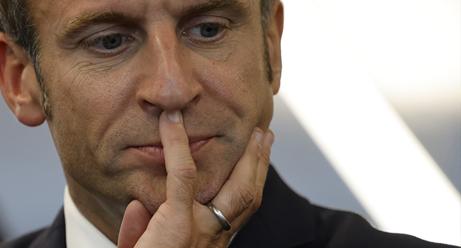 France's President Emmanuel Macron gestures as he visits a third place called "Le Quarante" in Laval, northwestern France, on October 10, 2022. (Photo by Ludovic MARIN / POOL / AFP)