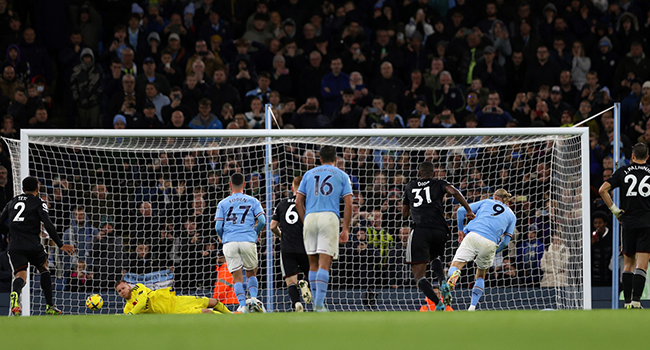 Manchester City's Norwegian striker Erling Haaland (2R) scores the team's second goal from the penalty spot during the English Premier League football match between Manchester City and Fulham at the Etihad Stadium in Manchester, north west England, on November 5, 2022. (Photo by ADRIAN DENNIS / AFP)