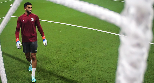 Qatar's goalkeeper #01 Saad Al Sheeb warms up ahead of the Qatar 2022 World Cup Group A football match between Qatar and Ecuador at the Al-Bayt Stadium in Al Khor, north of Doha on November 20, 2022. (Photo by Manan VATSYAYANA / AFP)