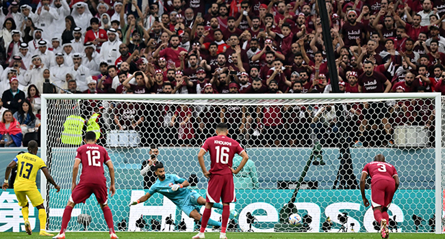 Ecuador's forward Enner Valencia (L) scores his team's first goal from the penalty spot during the Qatar 2022 World Cup Group A football match between Qatar and Ecuador at the Al-Bayt Stadium in Al Khor, north of Doha on November 20, 2022. (Photo by Glyn KIRK / AFP)