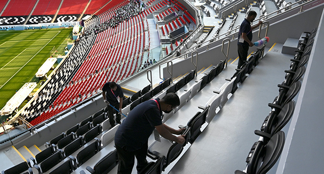 Workers clean seats at the Al-Bayt Stadium in al-Khor on November 12, 2022, ahead of the Qatar 2022 FIFA World Cup football tournament. (Photo by Gabriel BOUYS / AFP)
