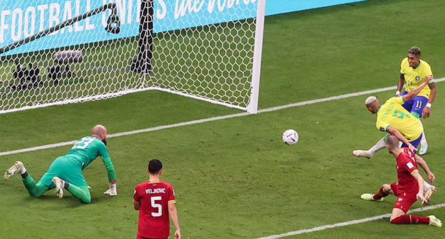 Brazil's forward #09 Richarlison scores his team's first goal during the Qatar 2022 World Cup Group G football match between Brazil and Serbia at the Lusail Stadium in Lusail, north of Doha on November 24, 2022. (Photo by Giuseppe CACACE / AFP)