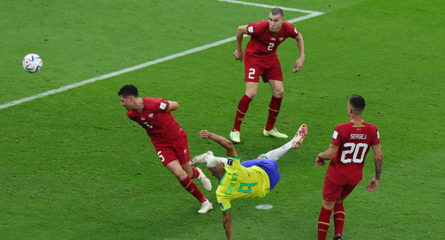 Brazil's forward #09 Richarlison scores his team's second goal during the Qatar 2022 World Cup Group G football match between Brazil and Serbia at the Lusail Stadium in Lusail, north of Doha on November 24, 2022. (Photo by Giuseppe CACACE / AFP)