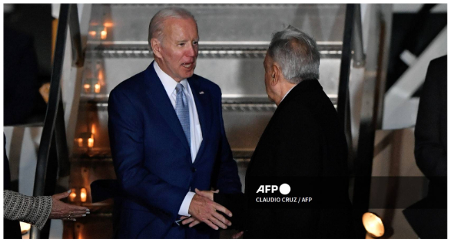 US President Joe Biden (L) is welcomed by his Mexican counterpart Andres Manuel Lopez Obrador upon landing at Felipe Angeles International Airport in Zumpango de Ocampo, north of Mexico City on January 8, 2023. (Photo by CLAUDIO CRUZ / AFP)