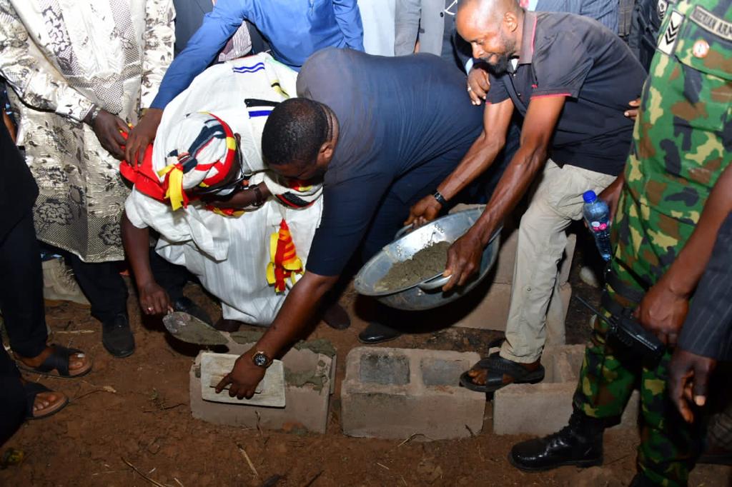 Chairman/Chief Executive Officer of NDLEA, Brig. Gen. Mohamed Buba Marwa (Retd.) CON, OFR, DSS; (m) assisted by others, laying the foundation of an NDLEA Area Command office in Igumale, Ado LGA Benue state while Chairman, House of Reps Committee on Drugs and Narcotics, Hon. Francis Ottah Agbo (standing l) observes the exercise.
