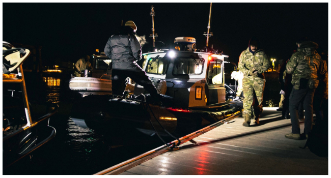 US Military personnel retrieve a huge white balloon carrying sophisticated equipment which traversed the continental United States last week.