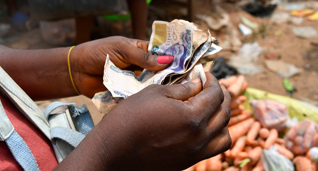 A vendor holds banknotes rejected by traders at Awgbu market in Anambra State, southeast Nigeria, on February 17, 2023.