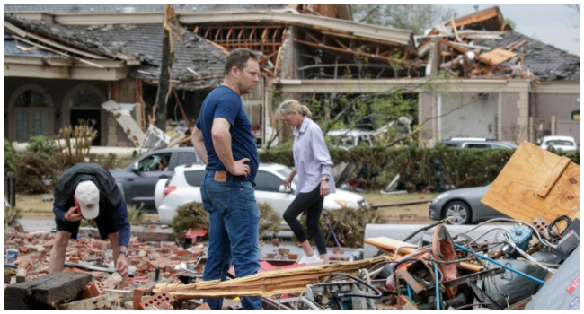 In this file photo taken on March 31, 2023, Kris French (C) and his family search through rubble for a video recorder they think captured a direct tornado strike to their business, Champs Car Wash, after a tornado damaged hundreds of homes and buildings in Little Rock, Arkansas. (Photo by Benjamin Krain / GETTY IMAGES NORTH AMERICA / AFP)