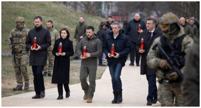 This handout picture taken and released by Ukrainian Presidential Press service on March 31, 2023, shows (L-R) Prime Minister of Slovakia Eduard Heger, President of Moldova Maia Sandu, Ukraine's President Volodymyr Zelensky, Prime Minister of Slovenia Robert Golob and Prime Minister of Croatia Andrej Plenkovic carrying candles to the place of mass grave at the St. Andrew and Pyervozvannoho All Saints church in the Ukrainian town of Bucha, (Photo by Handout / UKRAINIAN PRESIDENTIAL PRESS SERVICE / AFP)