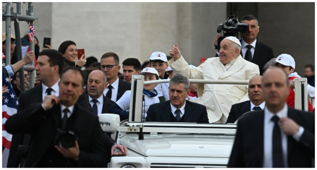 Pope Francis gestures towards attendees as he arrives in the popemobile car to hold the weekly general audience on April 5, 2023 at St. Peter's square in The Vatican. (Photo by Filippo MONTEFORTE / AFP)