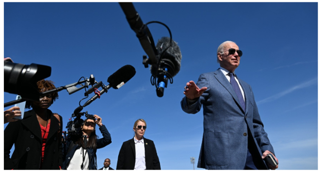 US President Joe Biden speaks to the press before boarding Air Force One, as he departs for Northern Ireland, at Joint Base Andrews in Maryland on April 11, 2023. (Photo by Jim WATSON / AFP)