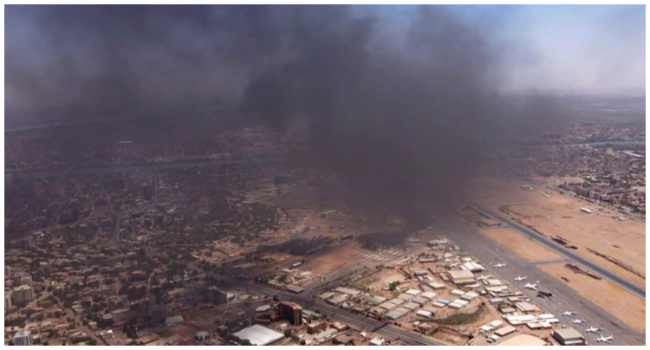 This image grab taken from AFPTV video footage on April 20, 2023, shows an aerial view of black smoke rising above the Khartoum International Airport amid ongoing battles between the forces of two rival generals.