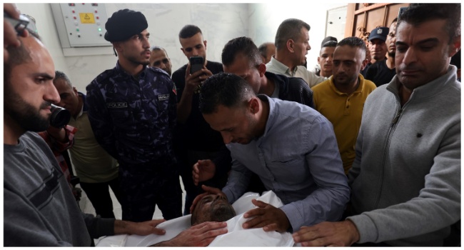 Graphic content / Mourners and family members gather around the corpse of Ahmed Abu-Deka, the deputy of the commander of a rocket launch unit killed by Israel, at a hospital morgue in Khan Yunis on May 11, 2023. Islamic Jihad confirmed it has lost five military leaders in Israeli strikes in recent days, including Abu-Deka. (Photo by SAID KHATIB / AFP)